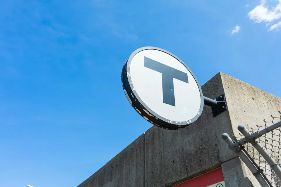 CLose-up of MBTA "T" logo on building.